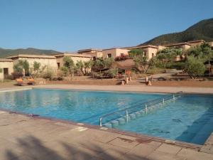 a large swimming pool in front of a building at Terres d'Amanar in Tahannout