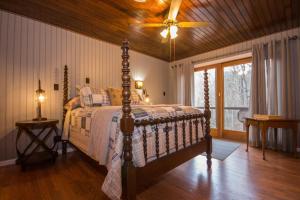 a bedroom with a bed with a wooden ceiling at Red Roof mountain cabin with Hot Tub, Starlink & Whole-house Generator in Stanley +25 photos
