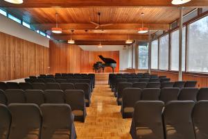 a lecture hall with a grand piano in the background at Stone Chalet Bed & Breakfast Inn in Ann Arbor