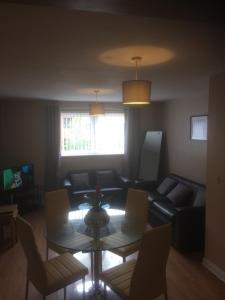 a living room with a couch and a table at Liverpool Apartments in Liverpool