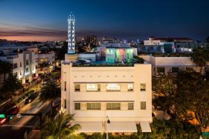 a white building with a clock tower in the city at The Tony Hotel South Beach in Miami Beach