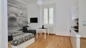 a bedroom with a bed and a table and a chair at P&D Apartments Navigli Ripa Ticinese in Milan