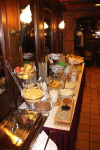 a buffet line with bowls of food on a table at Central-Hotel in Winterberg
