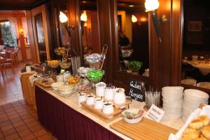a buffet with food on a table in a restaurant at Central-Hotel in Winterberg