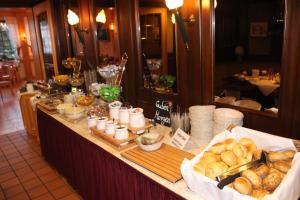 a buffet with bread and pastries on a table at Central-Hotel in Winterberg