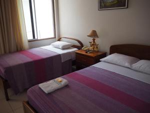 Postel nebo postele na pokoji v ubytování Hotel Peru Amazonico