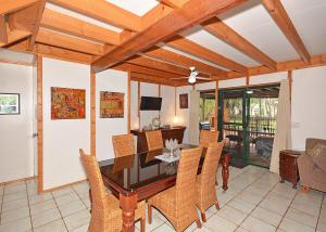 a dining room with a table and chairs at Bali on The Beach Absolute frontage-Lawn access in Toogoom