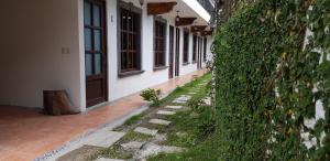 a hallway of a building with a ivy covered wall at Hotel Magnolia cuetzalan in Cuetzalán del Progreso +18 photos