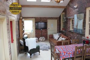 a living room with a brick wall at The Annex at Oliver Farm in York