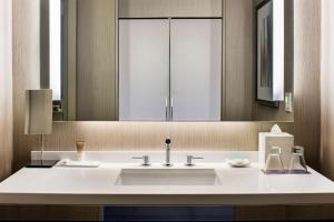 
a white sink sitting under a mirror in a bathroom at Hyatt Regency McCormick Place in Chicago
