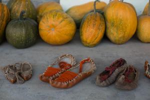 a group of pumpkins and shoes on a table at Armen's Guest House in Tatʼev