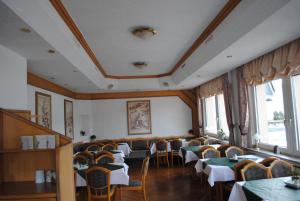 a dining room filled with tables and chairs at Landgasthof Gruss in Brilon