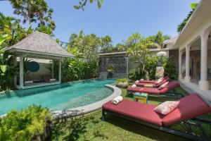 a swimming pool in the backyard of a house at Villa Sky Li by Nagisa Bali in Seminyak