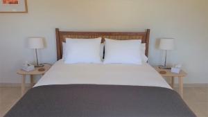 sypialnia z łóżkiem z 2 szafkami nocnymi i 2 lampami w obiekcie Finca Las Morenas w mieście Yunquera