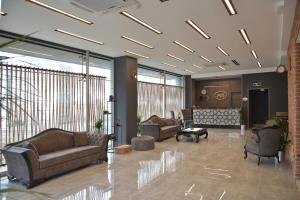 a lobby with couches and chairs in a building at A11 Hotel Atasehir in Istanbul