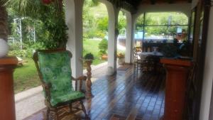 a porch with a chair and a table in the yard at Apartment Slavi in Vipava