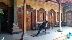 a woman is doing a yoga pose in a building at Ray homestay in Nusa Penida