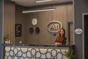 a woman standing in front of a counter in a salon at A11 Hotel Atasehir in Istanbul