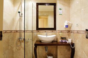 a bathroom with a sink, toilet and bathtub at Halepa Hotel in Chania