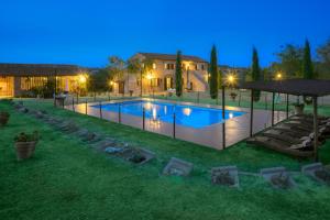 a swimming pool in the yard of a house at Agriturismi Farina in Castiglione del Lago