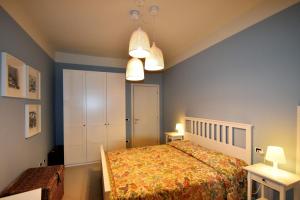 a bedroom with a bed and two tables and two lamps at Casa Marina by Holiday World in Ghiffa