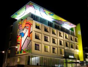 a building with a painting on the side of it at MaxOneHotels.com at Vivo Palembang in Palembang