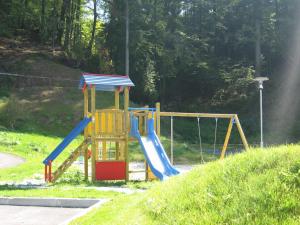 a playground with a slide in a park at Eco Terme Snovik in Laze v Tuhinju
