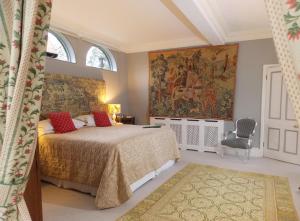 a bedroom with a bed and a painting on the wall at Rectory Manor in Lavenham +58 photos