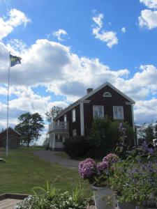 uma casa preta com uma bandeira no quintal em Snokebo Gård em Vimmerby