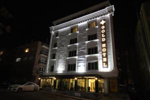a lit up building with a hotel sign at night at Ankara Gold Hotel in Ankara
