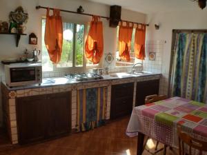 a kitchen with a sink and a stove at A Due Passi Dal Mare Con Piscina in Fontane Bianche