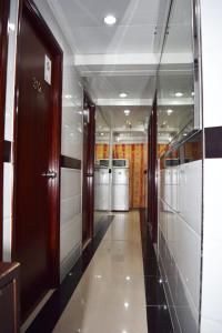 a hallway of a building with doors and trash cans at Om Guest House in Hong Kong