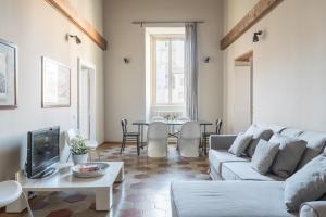 a living room with a couch and a table at Mami's Home Trastevere apt with private terrace in Rome +41 photos