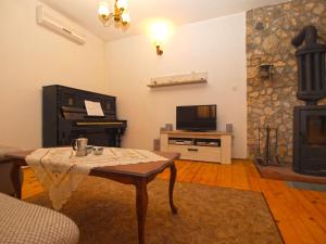 a living room with a table and a fireplace at House Fazana 975 in Fažana