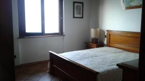 a bedroom with a bed and a window at Appartamento monteisola mara in Monte Isola +22 photos