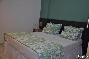מיטה או מיטות בחדר ב-Costa Brava Praia Hotel