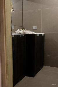 a bathroom with a black counter with a mirror at Vivi Vicenza in Vicenza