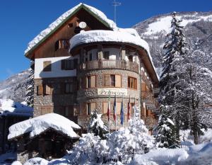 a large building with snow on the side of it at Grand Hotel Principe in Limone Piemonte