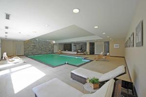 a large living room with a swimming pool at Maison Tissiere in Antey-Saint-André