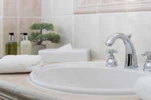 a bathroom with a sink and a white counter top at Hotel Landhaus Ellerbrock in Sankt Peter-Ording