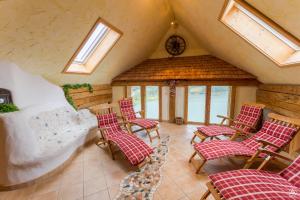 a room with chairs and a bed and windows at Gasthof Fischerwirt in Zeutschach