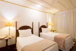 Cama ou camas em um quarto em Hotel Solar do Rosário