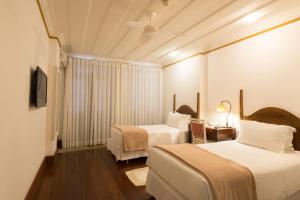 Cama ou camas em um quarto em Hotel Solar do Rosário