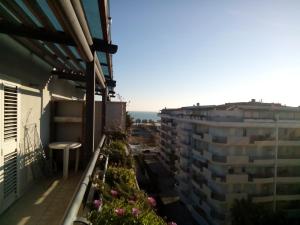 an apartment balcony with flowers and a view of the ocean at Attico Mansardato e Climatizzato con vista Mare in Montesilvano +12 photos