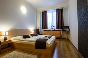 a bedroom with a large bed and a window at Penzion FIT - Contactless check in in Zvolen +30 photos