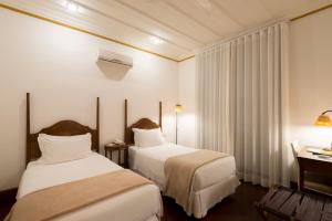 Cama ou camas em um quarto em Hotel Solar do Rosário