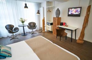 TV i/ili multimedijalni sistem u objektu Saillant Hotel Maastricht City Centre - Auping Hotel Partner