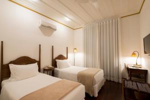 Cama ou camas em um quarto em Hotel Solar do Rosário