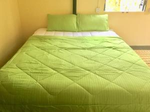A bed or beds in a room at Bunyong Homestay