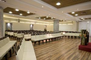 a conference room with white chairs and tables at Arena Hotel by the Beach in Bat Yam